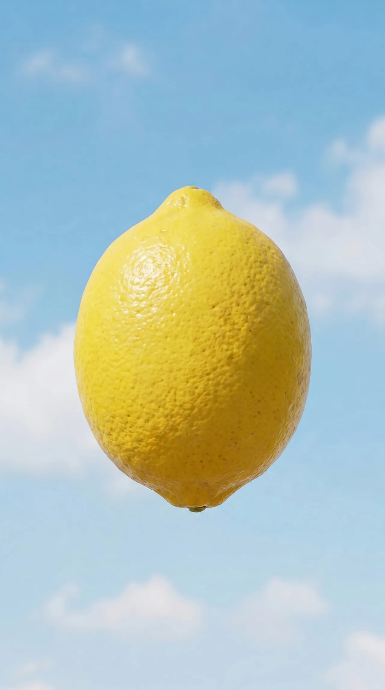 Single lemon floating in a cloudy blue sky