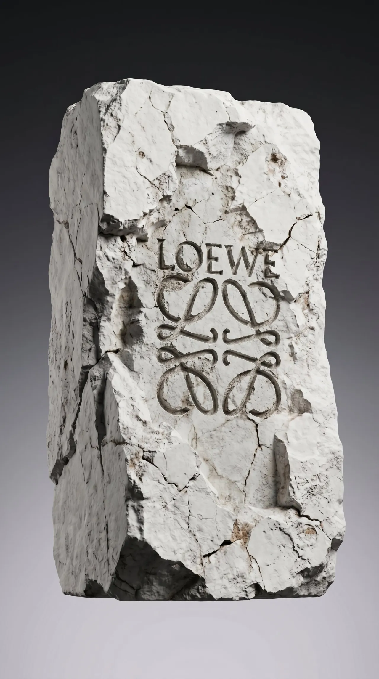Loewe anagram carved into a block of cracked white stone