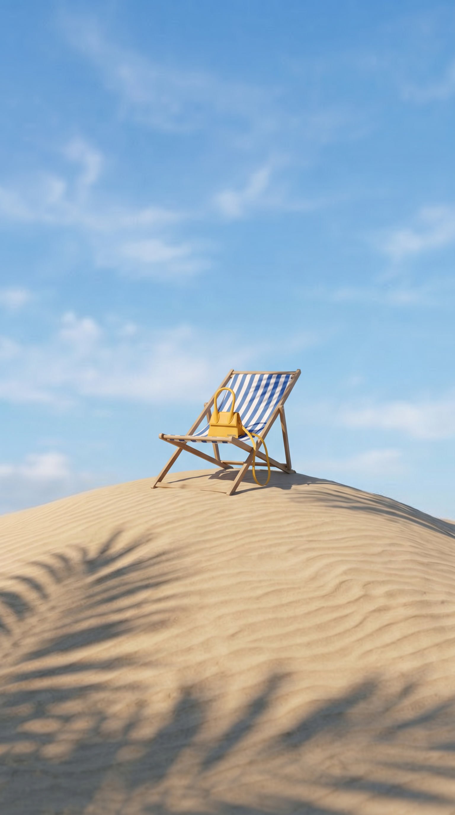 Top down view of Jacquemus bag in a basket with lemons and blue striped towels